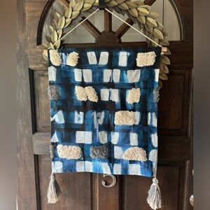 Small tapestry with blue accents and other fabric patches. Lovely for a nursery
